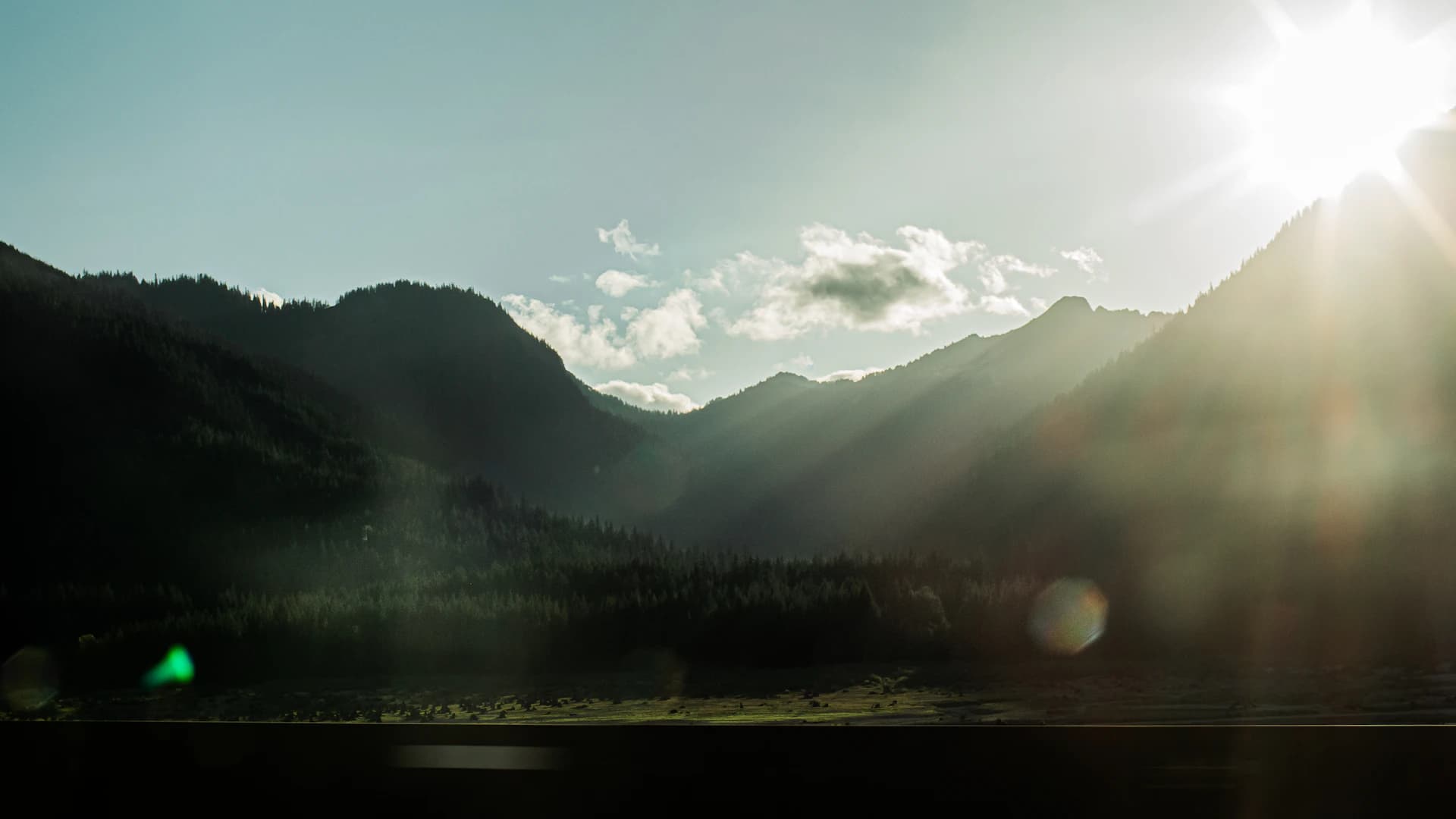 Sunlight over forested Cascade mountain ridges in Washington State